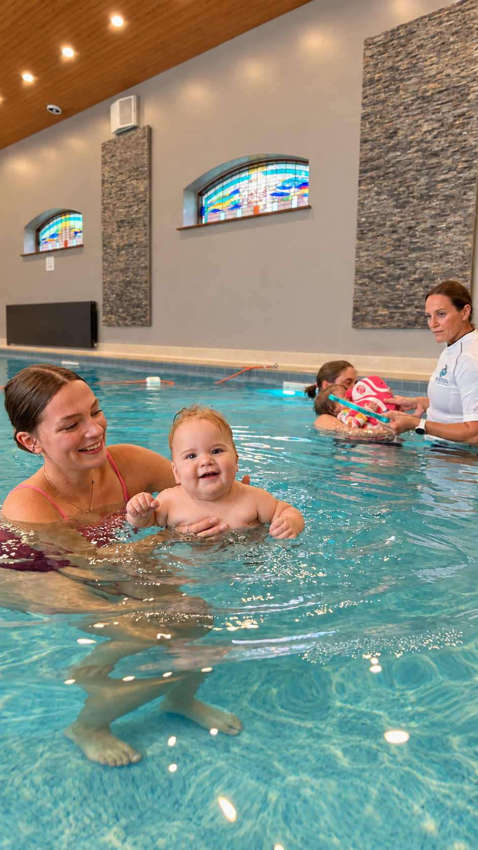 Parent supporting a baby in the swimming pool.